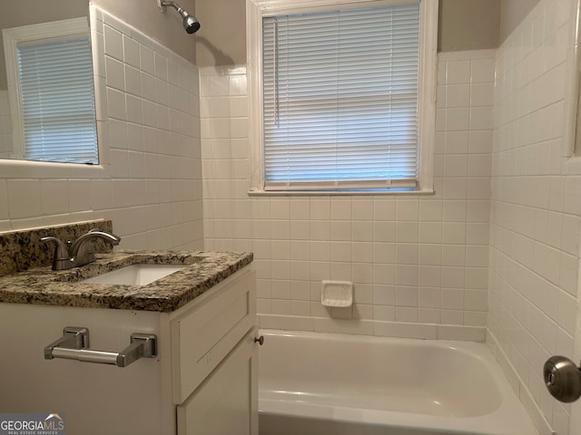 bathroom featuring bathtub / shower combination, vanity, and tasteful backsplash