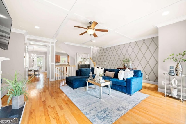 living room featuring ceiling fan, crown molding, wood-type flooring, and coffered ceiling