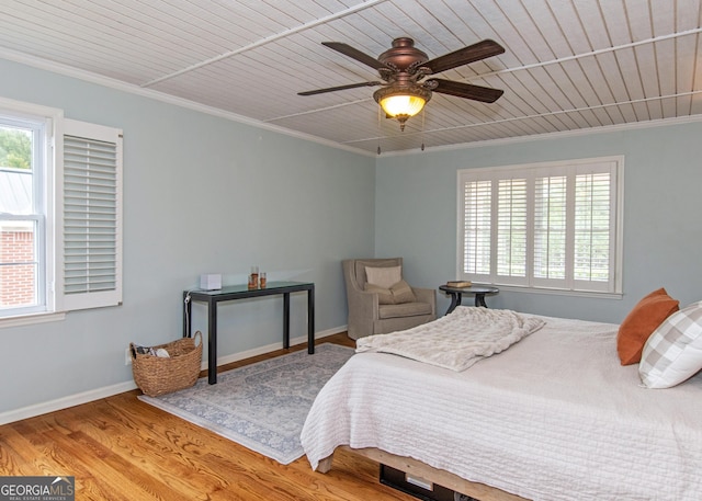 bedroom featuring ornamental molding, light hardwood / wood-style floors, ceiling fan, and wooden ceiling