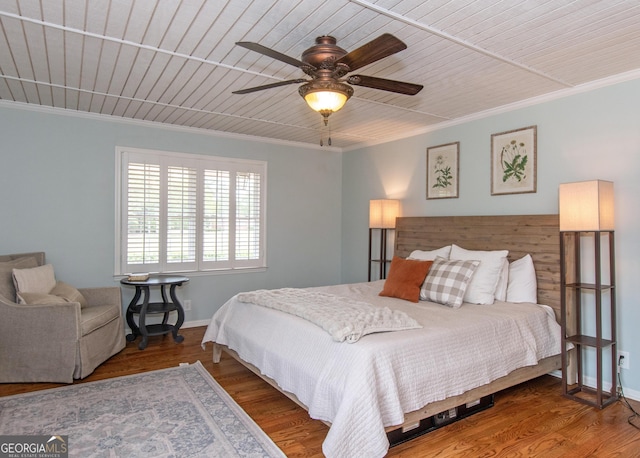 bedroom with crown molding, ceiling fan, and hardwood / wood-style flooring