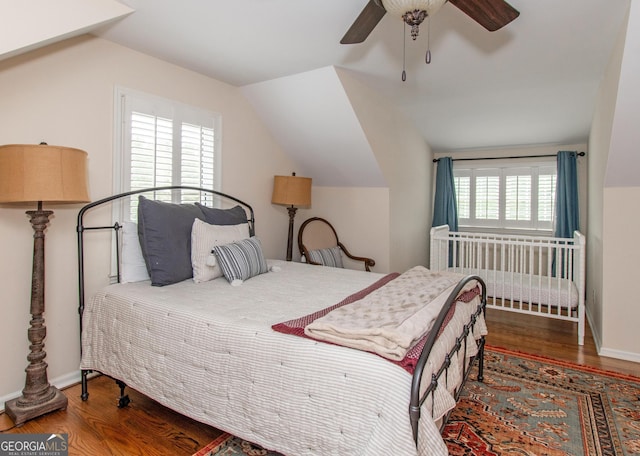 bedroom featuring multiple windows, ceiling fan, and hardwood / wood-style flooring