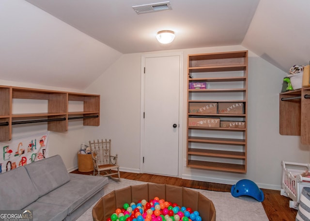 interior space featuring hardwood / wood-style flooring and vaulted ceiling