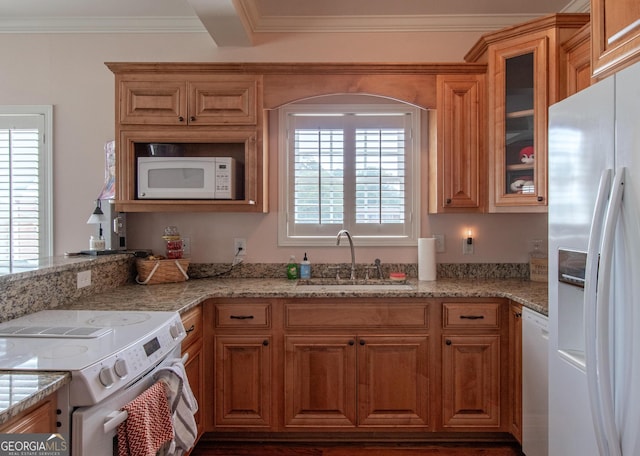 kitchen featuring crown molding, white appliances, light stone counters, and sink