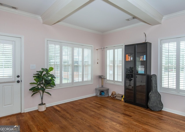 interior space featuring a healthy amount of sunlight, wood-type flooring, and beamed ceiling