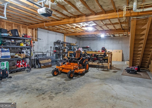 garage featuring a garage door opener and a workshop area