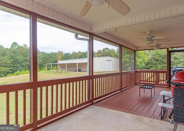 deck with ceiling fan and a yard