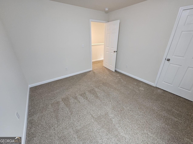 unfurnished bedroom featuring baseboards and carpet flooring