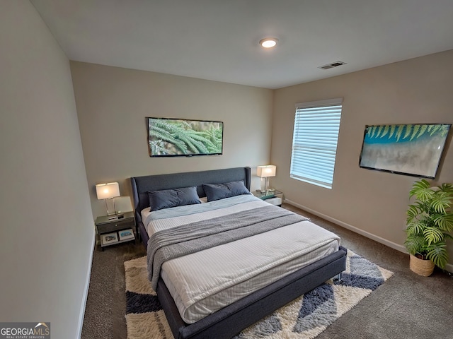 carpeted bedroom featuring visible vents and baseboards