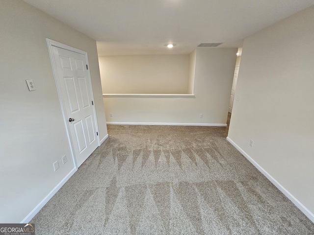 unfurnished room featuring baseboards, visible vents, and carpet floors