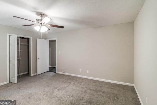 unfurnished bedroom with a textured ceiling, light carpet, ceiling fan, and a closet