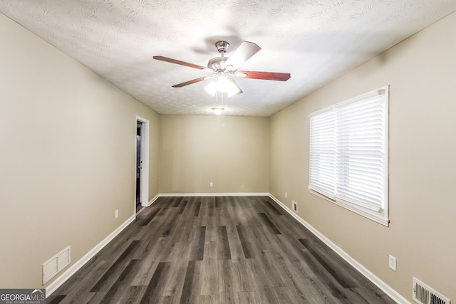 unfurnished room featuring ceiling fan, a textured ceiling, and dark wood-type flooring