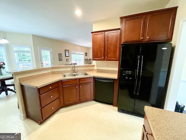 kitchen featuring black appliances, kitchen peninsula, and sink