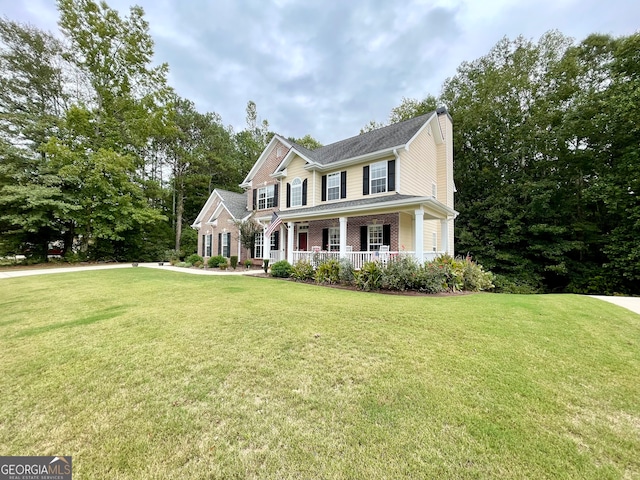 colonial inspired home featuring a front lawn and a porch