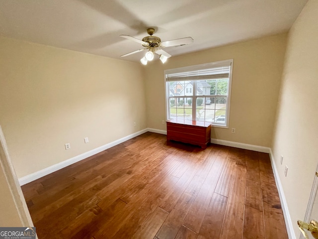 empty room featuring ceiling fan and hardwood / wood-style flooring