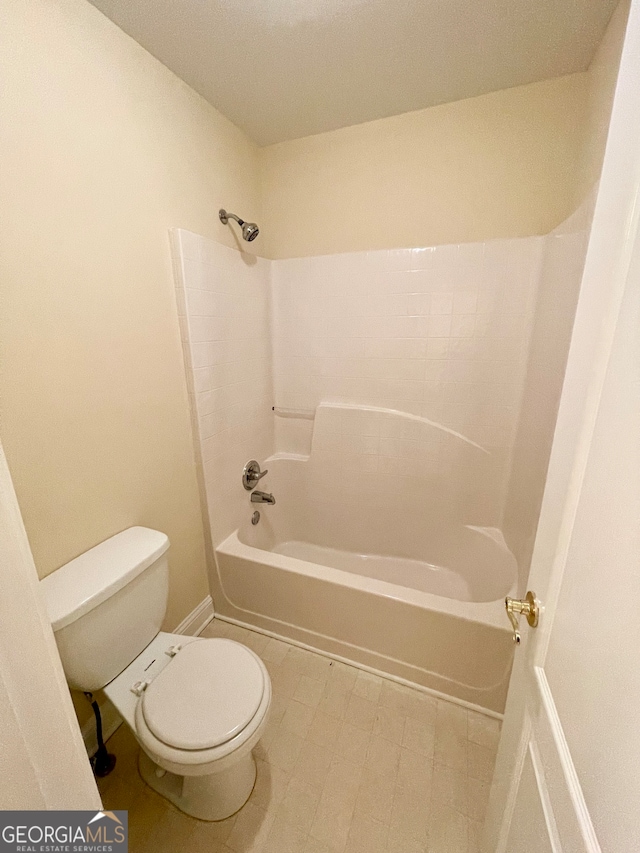 bathroom featuring shower / bath combination and toilet