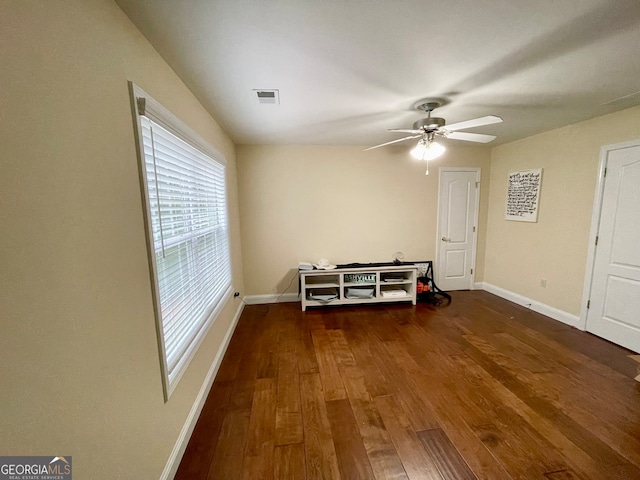 unfurnished room featuring ceiling fan and dark wood-type flooring