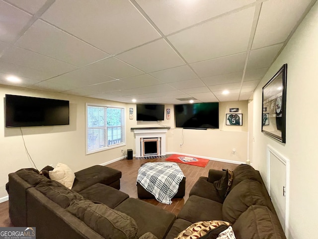 living room featuring a paneled ceiling and hardwood / wood-style floors