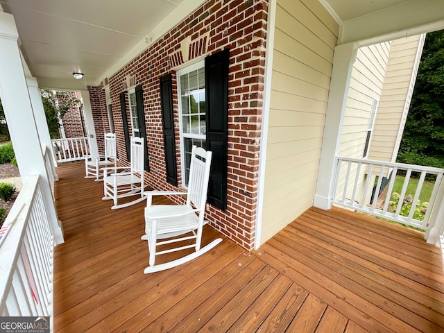 wooden terrace featuring a porch