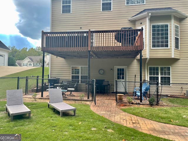 rear view of property with a deck and a yard