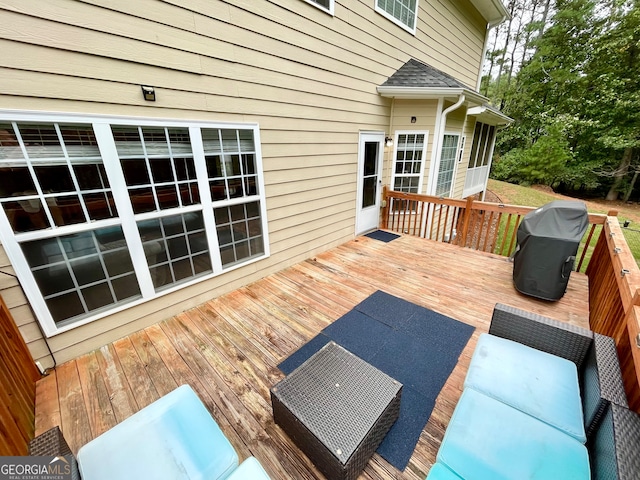 wooden deck with a grill