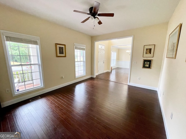 empty room featuring ceiling fan and dark wood-type flooring