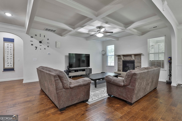 living room with beamed ceiling, a fireplace, ceiling fan, and dark wood-type flooring