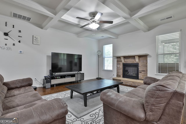 living room with beamed ceiling, dark hardwood / wood-style floors, coffered ceiling, crown molding, and ceiling fan