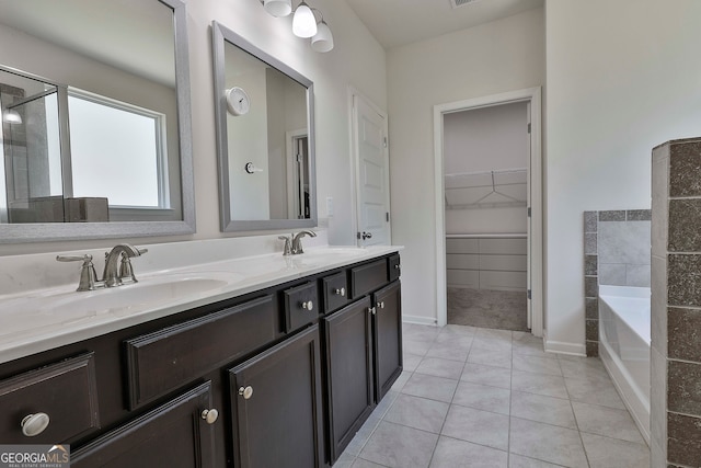 bathroom featuring a bath, vanity, and tile patterned floors