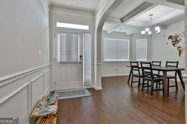 entrance foyer with coffered ceiling, dark wood-type flooring, beamed ceiling, crown molding, and a notable chandelier