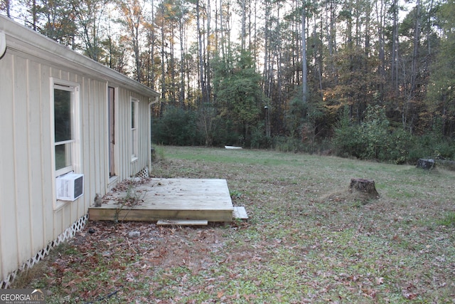 view of yard with cooling unit and a wooden deck