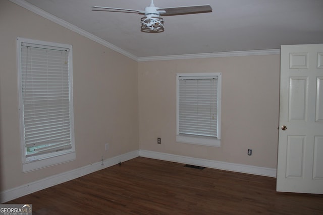 empty room with ceiling fan, dark hardwood / wood-style flooring, vaulted ceiling, and ornamental molding