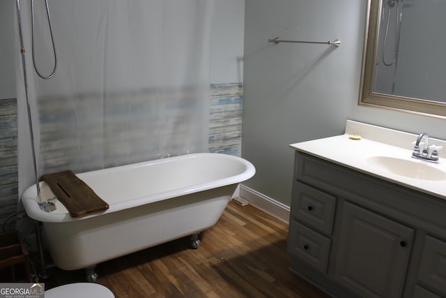 bathroom featuring hardwood / wood-style floors, vanity, and a bath