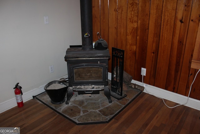 details featuring wood-type flooring and a wood stove