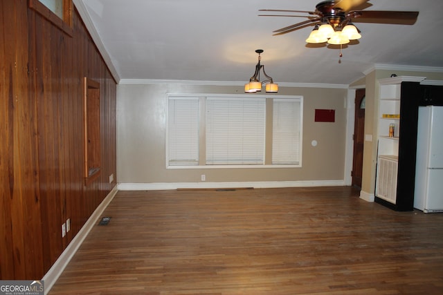 interior space with ceiling fan with notable chandelier, crown molding, and dark wood-type flooring