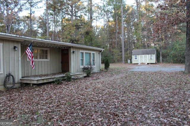 view of front of property with a storage shed