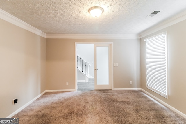 empty room featuring ornamental molding, a textured ceiling, and carpet flooring