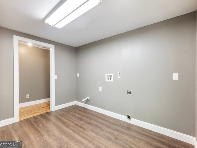 clothes washing area featuring hookup for a washing machine, hookup for a gas dryer, and hardwood / wood-style floors