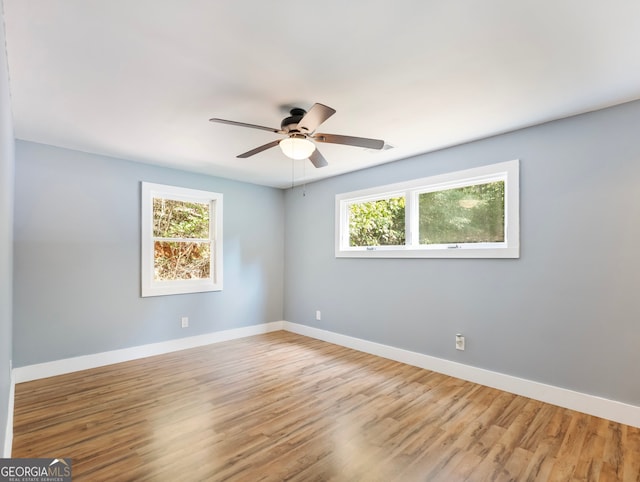 empty room with ceiling fan and hardwood / wood-style flooring