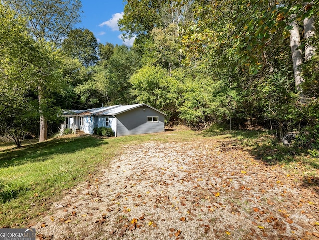 view of property exterior with a lawn