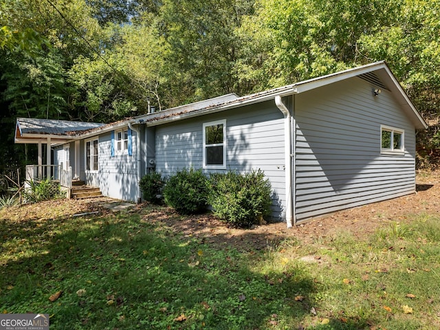 view of side of home with a lawn