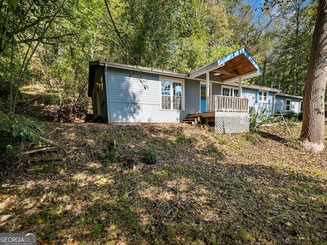 back of property featuring a deck