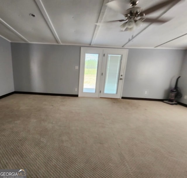 carpeted spare room with beam ceiling and ceiling fan