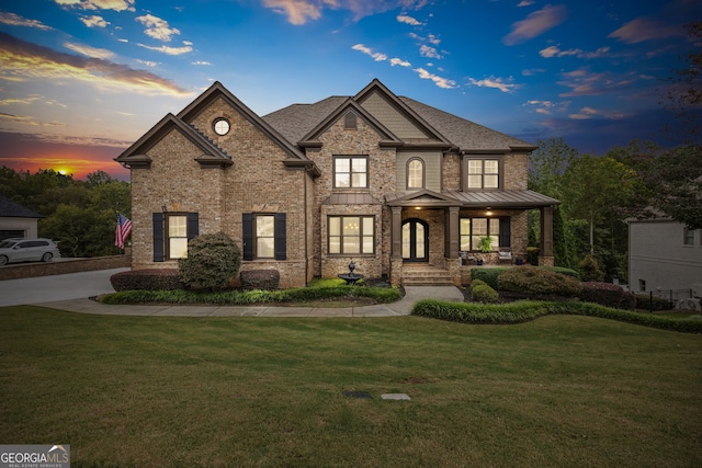 view of front of house featuring a porch and a lawn