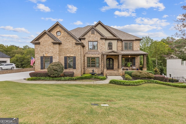 craftsman inspired home with a porch and a front lawn