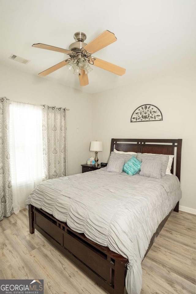 bedroom with ceiling fan and light hardwood / wood-style flooring