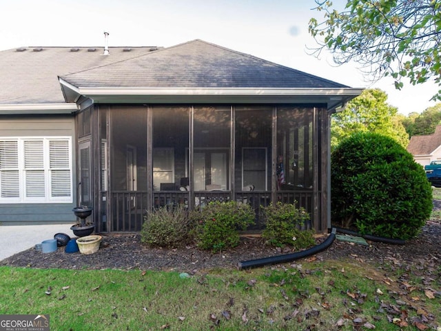 view of side of property featuring a sunroom