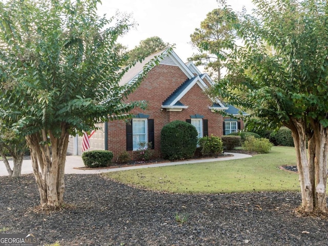 view of front facade with a front yard and a garage