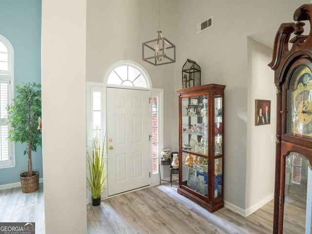 entrance foyer with a high ceiling and light wood-type flooring