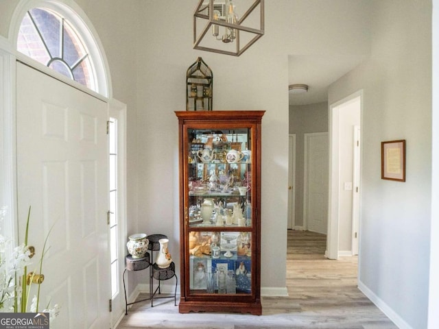 entryway featuring a chandelier and light hardwood / wood-style floors