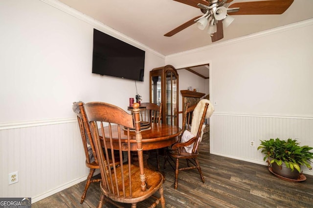 dining area with ornamental molding, ceiling fan, and dark wood-type flooring